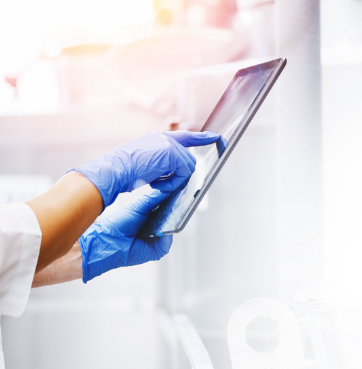 Healthcare_Worker_Wearing_Blue_Gloves_Using_Touchscreen